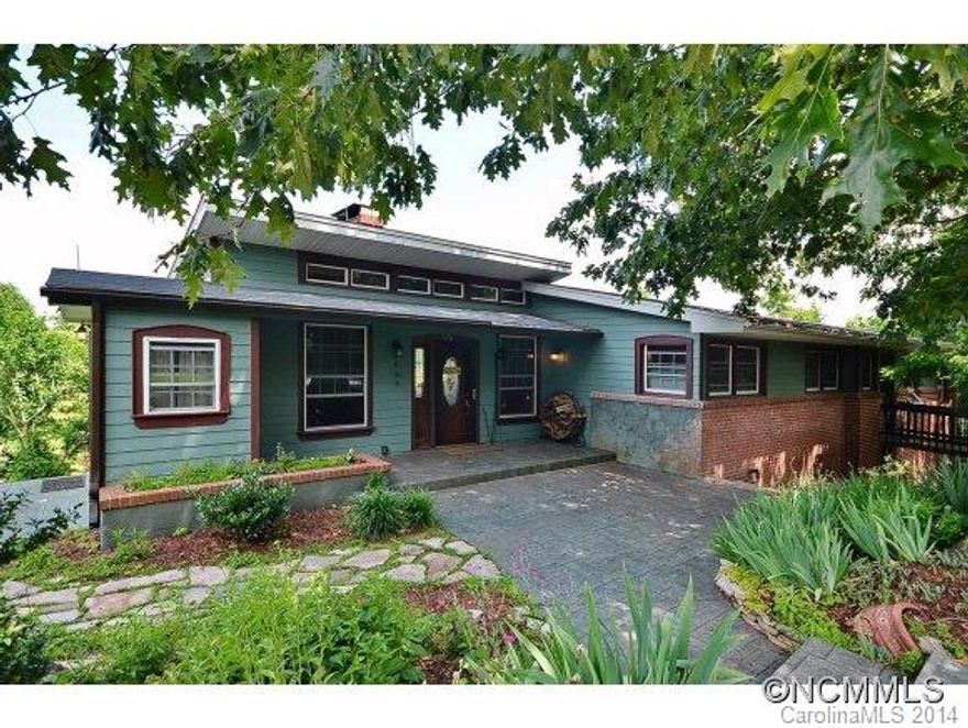 Get inspired at this Laurel Park cottage with breathtaking long range VIEWS. Inside, you'll find a peaceful merging of charm & nature. Airy floorplan w/ a fabulous kitchen with commercial gas range, granite, SS app, & lg island open to the LR. A stone fireplace & picture windows set the tone there. Master suite w/ views & upgraded bath w/ marble walk in shwr. Ofc & den on opposite side. Lg Bsmnt, wrap deck, grt location, complete reno in 2006!