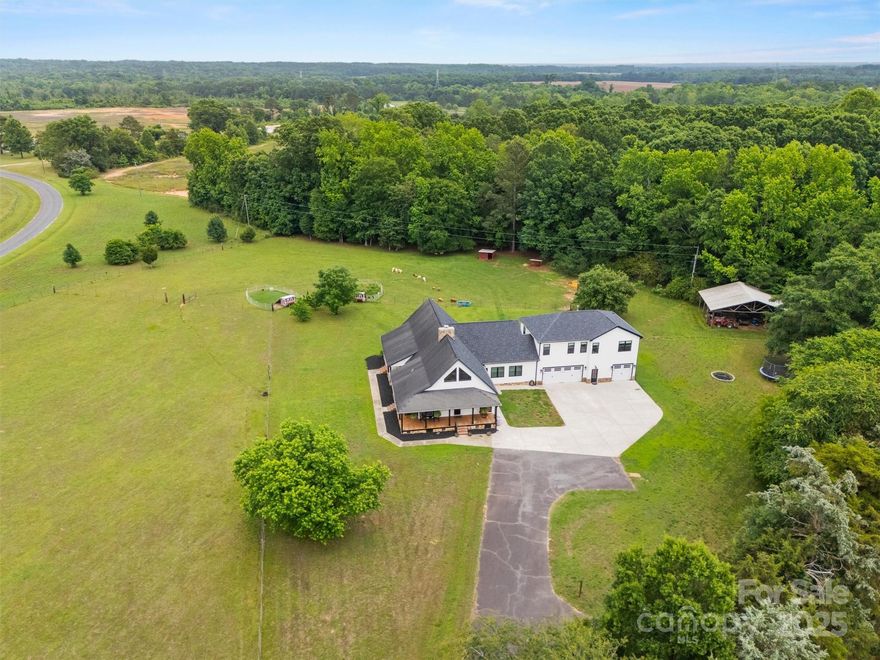 Multi-Generational Home Nestled on 18 Picturesque Acres, this Stunning A-Frame Farmhouse-Style Home Seamlessly Blends Rustic Charm with Modern Luxury. From the Moment you Drive up the Private Tree Lined Drive to Stepping onto the Covered Wrap Around Porch you will be Captivated. Step inside to be greeted by Beautiful Wood Flooring, Soaring Ceilings w/Exposed Wooden Beams, and a Cozy Stone Fireplace that Anchors the Living Space. The Open Floor Plans Features a Split Bedroom Floor Plan w/a Spacious Private Primary Suite that Offers a Spa-Like Oasis Full Bath. UP Stairs you will find the Perfect Guest Suite w/a Private Bedroom, Full Bath & Loft. Additional Loft Up is the Perfect Kid Retreat. An impressive 2-Bedroom/2-Bath Apartment above the 3-car Garage Adds Versatility—Ideal for Guests, In-Laws, or Potential Rental Income. With its Expansive Acreage, 2- Fenced Pastures, Breathtaking Views, and a Blend of Classic and Modern Design, a Rare Gem waiting for You to Call it Home.