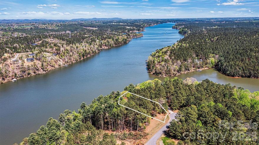 Harbor Ridge - 106 Pier Point - 1.13 Acre Lakefront Lot - 141.5' Lake Frontage 
Discover the perfect canvas for your dream home on this lakefront lot in the gated Harbor Ridge community. This 1.13-acre parcel offers main channel living on Lake Rhodhiss, a hidden gem known for its tranquil waters, quiet coves, and recreational opportunities—ideal for boating, fishing, kayaking, or simply soaking in the natural beauty. Lake Rhodhiss is a favorite among nature lovers and those seeking a peaceful retreat with year-round enjoyment. Harbor Ridge is an established lakefront community offering residents secure gated access, boat storage, day docks, and more.  A lovely opportunity to create a custom lake retreat where mornings begin with sunrise views and evenings end with serene sunsets. Don’t miss this opportunity to live lake life to the fullest—where community, nature, and convenience meet.  Close proximity to I-40 - ideally situated for travel to Hickory, Charlotte & Asheville.