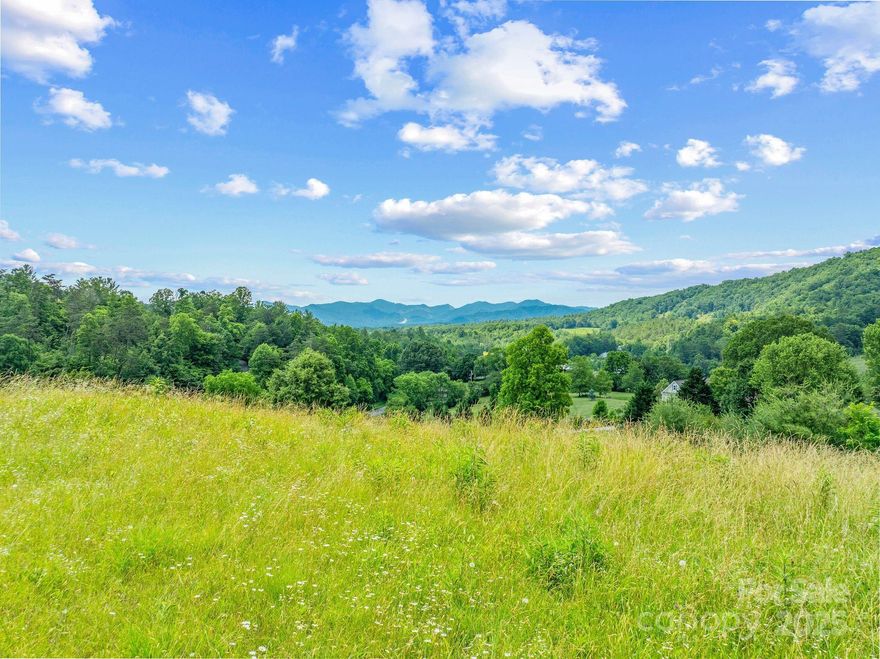 Welcome to your future home site. This 6 acre lot boasts long range unobstructed views to the Tennessee Gap, and presents a perfect canvas for building your dream home. While visiting the acreage you'll be greeted by long range views that provide a serene setting yet proximity to neighbors. The lot provides paved road access, cut in driveway, underground power with available high speed internet. Let your imagination run wild with the large flat partially cleared area, or choose one of the many other possibilities on your 6 acre piece of paradise. The Seven Glens Community is an established neighborhood located close to Mars Hill and Weaverville and the approved new AdventHealth hospital.  Only 25 minutes to downtown Asheville with its world famous restaurants, art, breweries, and outdoor activities. There is an expired septic permit for a 4 bedroom home.  Subdivision of the lot requires HOA approval. https://video-playback.web.app/ItOt7SMaPzygiOoas7PF7vji8TWLApAH79QQCY5pr01s