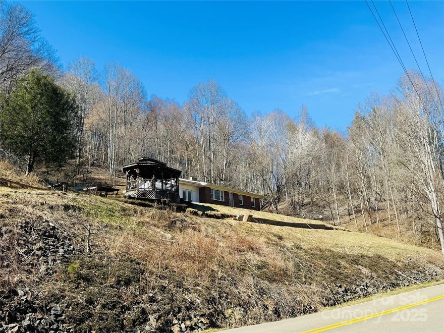 This charming brick home located just minutes for downtown Lansing is nestled on 6.84 acres of woods and some open pasture, this home offers the perfect blend of rustic charm and modern updates. The property is fully fenced, making it ideal for animals or those who enjoy the outdoors. Inside, you'll find beautiful hardwood floors throughout and an updated kitchen that seamlessly blends function and style. The home features 3 bedrooms, with one currently converted into a convenient laundry room. The open living room creates a welcoming atmosphere, enhanced by barnwood accents on the walls for a cozy, farmhouse feel. The spacious master bedroom, which could also be used as a sunroom, offers a serene retreat. The property boasts both road frontage and access to a stockable Big Horse Creek, adding to its appeal for nature lovers and all the fishermen out there. Additionally, a full basement provides ample storage space or room for further expansion.