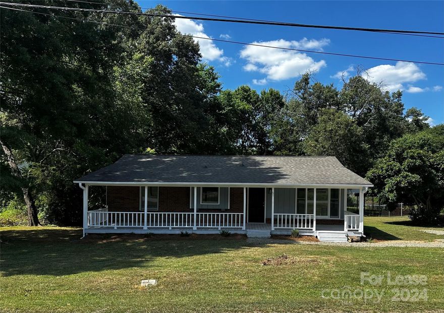 SPACIOUS INSIDE AND OUT - This 2 bed 2 bath 1,072 Sq Ft renovated house located in Concord, NC is just waiting for you to call it home! A rocking-chair front porch welcomes guests in.  The family room features a large picture window, allowing for plenty of natural light. The adjoining dining room and kitchen lead to a large back deck.  This is perfect for entertaining and overlooks the lovely backyard. Kitchen upgrades include new soft-close white shaker cabinets, quartz countertops and new black appliance package (dishwasher, refrigerator, range and over-the-counter microwave). A large primary bedroom includes an en-suite bath with new fixtures and access to the rear deck. An additional bedroom and full upgraded bath complete the home.  New LVP flooring has been installed in all common areas, as well as new carpet installed in the bedrooms. A nicely-sized shed in the backyard allows for storage and a workshop.  This is wired for electricity, for your convenience.