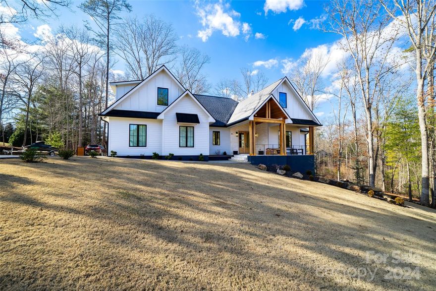 Welcome to this charming farmhouse-style home nestled in the serene Mountain Shadows neighborhood. This wonderful property boasts 3 bedrooms, 4.5 bathrooms, a bonus room, and a luxurious sauna, offering a perfect blend of comfort and tranquility. Upon entry, you're greeted by a warm and inviting interior, characterized by its rustic farmhouse aesthetic. The open-concept living area features exposed beams, engineered white oak hardwood floors and a cozy fireplace, creating a welcoming ambiance for gatherings and relaxation. The kitchen is equipped with great appliances, ample cabinet space, and a large center island, perfect for preparing and enjoying meals with family and friends. The primary suite is a true retreat, complete with a spa-like ensuite bathroom featuring a soaking tub, dual vanities, and a spacious walk-in closet. This home offers a tranquil setting while still being only 15 min from Downtown Asheville. Don't miss your chance to own this exquisite farmhouse-style home!