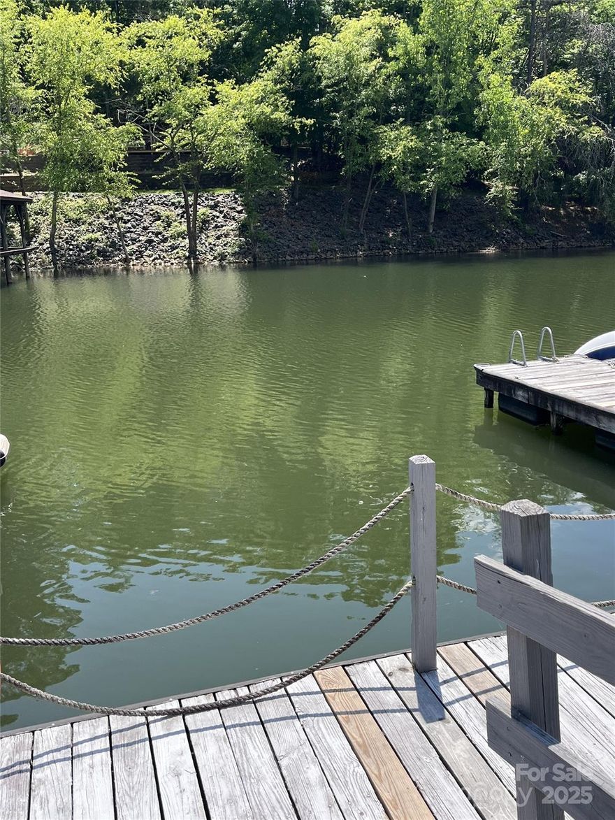 Live the Lake Wylie lifestyle in this beautifully updated 3BR/2.5BA Tega Cay peninsula home with direct water access, neighborhood dock, and deeded boat slip—perfect for boating and water enthusiasts. Skip the marina hassle and enjoy lake days right from your backyard. Features include a main-floor primary suite, vaulted ceilings, custom shelving, quartz kitchen countertops, new stainless appliances, and modern bathrooms w/ marble & walk-in tile showers. A spacious upstairs flex room can serve as a 4th bedroom, office, or gym. Upgrades: new LVP flooring, lighting, roof, HVAC, gutters, interior/exterior paint, and epoxy garage floor. Walk to Windjammer Park and enjoy Tega Cay amenities: golf, pickleball, pool, and award-winning Fort Mill Schools. Close to Charlotte (16 mi), Uptown (18 mi), and Whitewater Center. Ditch the marina fees—Lake Wylie boating begins at your doorstep -  kayaking, paddle boarding, water skiing or trail walking -  opportunity awaits!