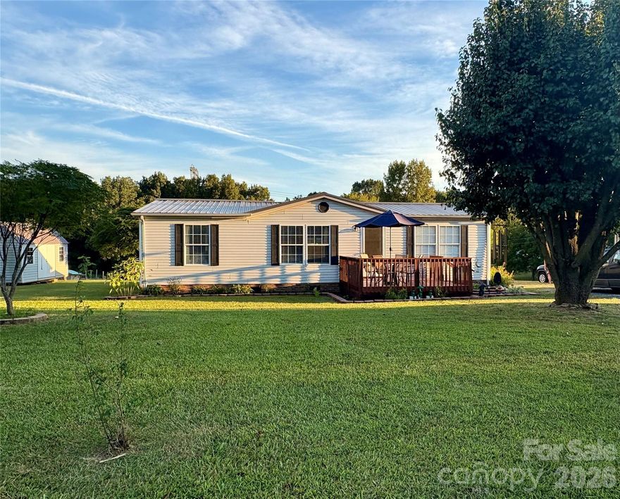 Charming Country Estate on 1.22 Acres is calling your name! If you want affordable, peaceful, and private...your search is over. Three bedrooms, 2 full baths. Primary ensuite with dual vanity and walk in closet with ample storage space. Large Great room that is open to spacious kitchen. All appliances remain! Dishwasher and dryer were new in 2025. Tons of counter top space! Split bedroom plan with cozy bedrooms and a bath opposite of the primary ensuite. Laundry room at back of home leading out to an amazing back yard. The views are serene. Great deck for relaxing. Two storage buildings! This one will not last long. Clean and taken care of. Call today!