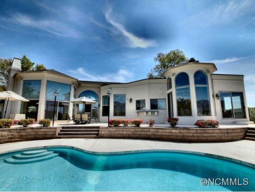 Sweeping views of Lake Lure and the Chimney Rock Mountains provide the frame for this thoughtfully designed hilltop estate. One level living invites all who enter to experience a panorama of breathtaking views from almost every room.  The spacious Master Suite with a fireplace is privately located from the two guest suites and third guest/study. A 2-car garage, in-ground pool, and a double boathouse on the waterfront complete this inspired home.