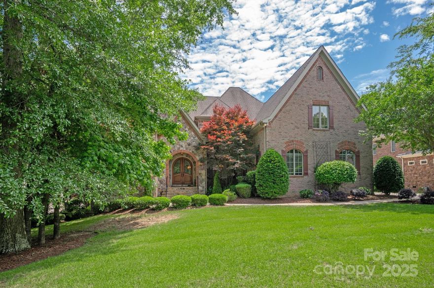 Tucked on a quiet street in prestigious, gated Providence Downs South, this estate offers a level of sophistication and luxury that is one-of-a-kind. Expansive common spaces, updates throughout and private wooded backyard. Kitchen has double island with professional level appliances.  The main level is anchored by breathtaking 900 sq ft primary suite, complete with private fireplace, sitting area, spa-inspired bath, and second laundry room. Upstairs, four generously sized bedrooms, each with its own luxurious ensuite, and versatile bonus room perfect for use as an additional bedroom or playroom. Fully finished basement with 7th bedroom and entertaining galore!  Oversized 3 car garage, extended drive and exterior storage in basement for lawn equipment.  Boasting nearly 10,000 square feet, this estate represents the pinnacle of luxury living. Residents of PDS enjoy world-class amenities: tennis, basketball, a resort-style pool with a lazy river, clubhouse, fitness center and more!