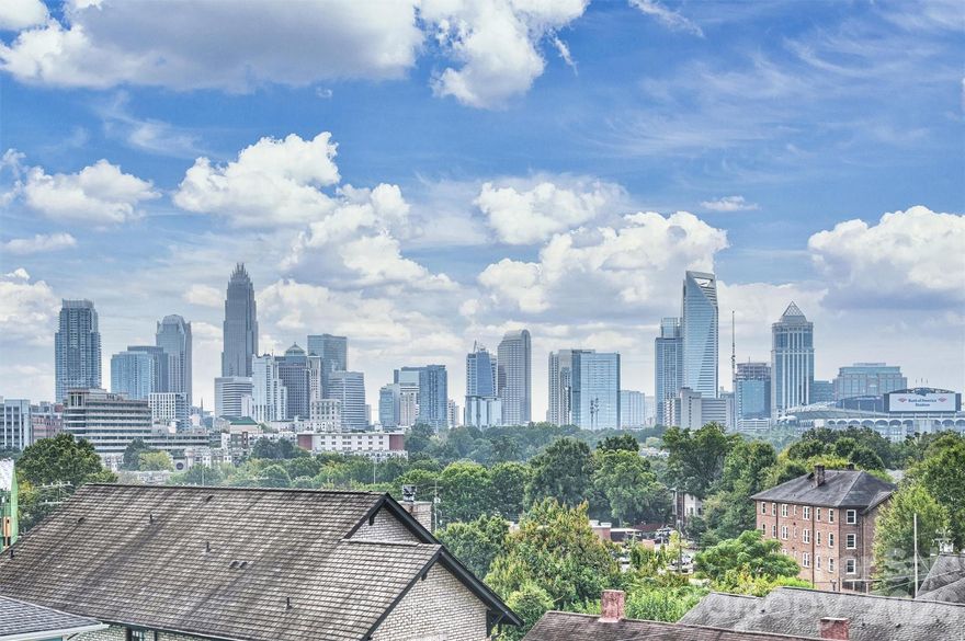 Luxury rooftop townhome with panoramic Uptown Charlotte skyline views and a terrace designed for unforgettable evenings. Rare move-in ready 3-bedroom rooftop townhome featuring an impressive list of interior upgrades, including a dry bar, hardwood floors throughout, custom blinds, and a flexible floor plan designed for modern living. Freshly painted and flooded with natural light, oversized windows are thoughtfully positioned to showcase the dramatic city skyline. The expansive rooftop terrace faces directly toward Uptown, creating a breathtaking backdrop for entertaining or relaxing while enjoying sweeping skyline views that stretch for miles. Ideally located just minutes from Center City, blocks from the Greenway, and two blocks from the Lynx Gold Line Wesley Heights Station, this home offers unmatched convenience. Neighborhood favorites—including Pinky’s, Burger Company, Rhino Market, Town Brewing, and a host of new dining and gathering spots—are just steps away, and walkability continues to grow as the area develops. The lower-level third bedroom with a full bath provides an ideal space for guests, a private office, or a quiet retreat separate from the main living areas. With a two-car garage and thoughtfully curated upgrades throughout, this home offers a rare opportunity to enjoy elevated city living with exceptional skyline views in a well-established, vibrant community.