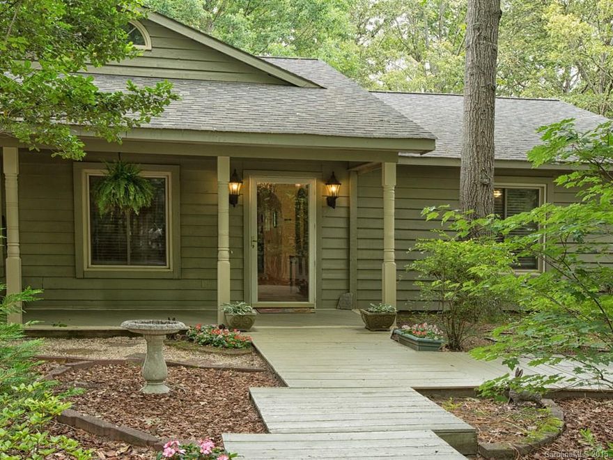 Charming ranch home with lots of character with a circular drive on 1.78 acres.  Fresh inter/exter paint, beautiful stone fireplace, open floor plan, study, sunroom, bonus, large screened in porch and extra attached room for workout/storage/workshop.  Master bedroom with sitting area and large master closet.  Too many updates to list! Unique built-ins throughout.  Features include new AC/Heating & new roof in 2011, new well pump 2012, new septic system 2014. Close to Tega Cay & Fort Mill