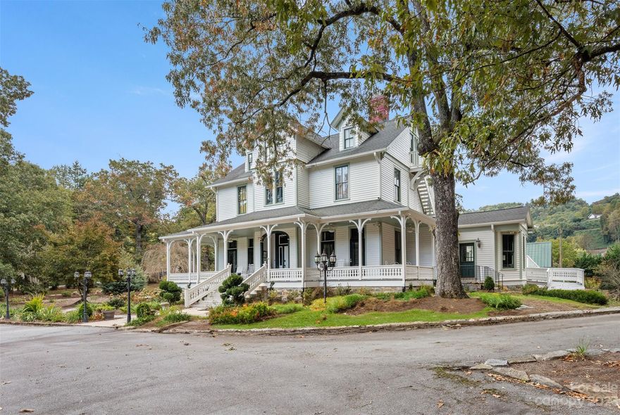 The Henderson Estate:  an impeccably-restored Picturesque-style estate home set on 4.6 acres of private land in the Laurel Park area.  It's a world onto itself, just minutes from Downtown Hendersonville.  Built in 1865 by respected banker William J Davis, the estate is a one-of-a-kind property with a rich, local history.  It also sits alongside the Ecusta Trail, a former railway line now being transformed into 19.4 mile recreational trail.  Enter the stately entry hall, and marvel at 12-foot, vaulted ceilings.  You'll immediately embrace the magnificent original staircase.  The 5,613 sqft home has seven bedrooms, seven full bathrooms, with a modern kitchen and modern bathrooms.  This may be the perfect place to call home, or consider enrolling it into a vacation rental program for income.  On the property you will also find an antique carriage house and antique stone building, each with the potential for different uses.  This property must be seen.