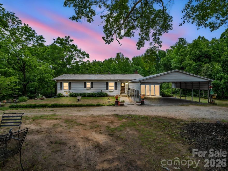 Lovely 3 BR, 2.5 bath home with lots of updates & situated on 3.65 acres! Updates include a new metal roof in 2022, new HVAC system in 2025, new flooring in kitchen, laundry rm, & 1/2 bath in 2022, new Anderson windows in basement and also sitting area on main level in 2024, new dishwasher 2024, new double metal carport in 2023.  As you enter the home, you'll find a sitting area with fireplace, the primary bedroom with ensuite bath & lots of closets, and the other two bedrooms with another full bath off the hall. The open staircase leads to the daylight basement with a large family room that has another fireplace, a large kitchen, the laundry room, and a half bath.  Lots of wood in this home with wood ceilings throughout. There is also a carport attached to the home but it has been closed-in for storage.  At the back of that carport is a small workshop area. There are three storage buildings. A concrete drive leads to a large patio out back that is partially covered - great for enjoying the private backyard or entertaining!  The backyard also has a firepit and a fenced area for your pets.  There's a space for an RV and there are hookups but sellers have never used them and do not guarantee that they still work. Home is very clean & move-in ready!  Convenient to Hwy 74 and approx. 1 hour to Charlotte, Spartanburg/Greenville, or Asheville. Don't miss this one!