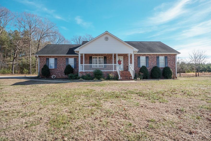 Welcome to your dream home in a tranquil country setting! This 3BR, 2BA brick ranch offers over 1500 SF and a functional floor plan with hardwood floors throughout  the living area. The kitchen offers informal seating at the bar, 2 pantries, and a nice open area to enjoy family meals. The sunroom brings the outdoors in, creating a perfect spot to enjoy the changing seasons. With a double attached garage, single detached carport, enclosed single carport, and two storage buildings, convenience is key. Situated on 1.29 acres provides plenty of space for outdoor activities, gardening, and enjoying the scenic surroundings. This charming home combines comfort, functionality, and space in a serene setting. Welcome to your new haven!