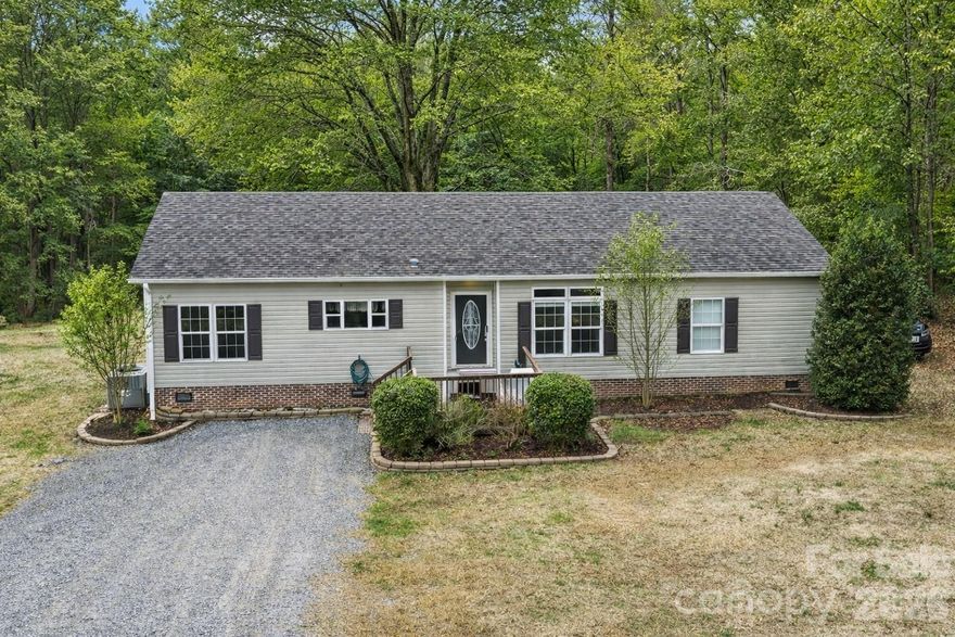 Country living with room to breathe in Gaston County! Situated on 2.17 acres (partially wooded/partially cleared) in Gastonia, this 2013 on-frame modular home offers just under 2,000 sq ft with 4 bedrooms and 2 full baths—all on one level. Enjoy a quiet road setting with a gravel drive and the home set back for extra privacy, plus an updated deck that’s perfect for relaxing and enjoying the outdoors. Plenty of parking and no HOA add to the freedom and convenience of this property. Inside you’ll love the open floor plan with 9-foot ceilings, a split-bedroom layout, spacious laundry room, and a kitchen with island plus abundant cabinetry and natural light from lots of windows. Recent updates include new flooring, fresh interior paint, new carpet in all bedrooms, and a renovated hall bath. A little cosmetic TLC remains—ideal for someone handy who wants to add finishing touches without major projects. The home sits on a permanent brick foundation. All appliances convey, including refrigerator, washer, and dryer. Well and septic. Eligible for USDA, FHA, VA, and conventional financing. Motivated sellers—come tour and see the potential! I hope your folks love it!