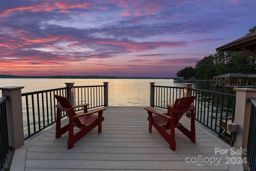 This stunning Lake Norman waterfront home truly has it it all! New & beautiful fresh new paint throughout.  4 BDRM and 4 BA this home boasts a prime west-facing view, and views for miles with some of the most magnificent sunsets on Lake Norman. The floor plan lives like a dream with primary on main, large living space and open kitchen with floor to ceiling windows showcasing lake views in nearly room. Enjoy the chef's kitchen with double ovens and 5 gas burners perfect for culinary enthusiasts and hosting gatherings with loved ones. The property has a private composite deck with a covered dock, cable boat lift and walk way out to the water. The 3 car garage offers plenty of parking space or storage, sealed crawl space with more storage under the home & walk in attics. Master bath has been recently remodeled as well as new addition of finished exercise room. Professionally landscaped, located in a private area.  If desired, join the Point with a pool, golf, pickle ball & more.