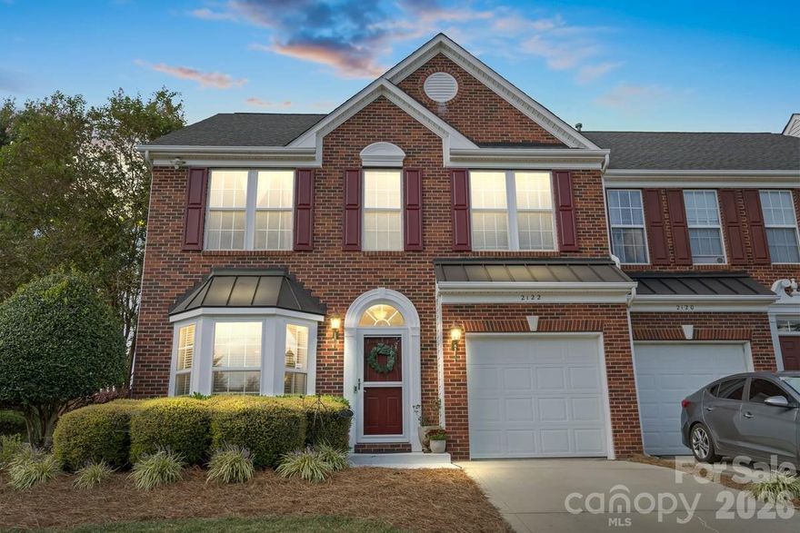 Beautiful former MODEL HOME built with all the bells and whistles, and additional Owner updates.  Shows Pride in Ownership and move in ready!  Don't hesitate on this one, schedule your showing today!!  Desirable Holly Park in Indian Trail.  3 bedroom/2.5 baths with 1964 sq ft.  Two story great room with molding all the way up the wall, gas fireplace, and gleaming hardwood floors throughout the first level and stair treads.  Kitchen boasts a bay window, stainless steel appliances (new dishwasher) and upgraded granite counters/backsplash.  Refrigerators inside and in garage are included.  Primary suite on main w/tray ceiling, beautifully hand painted by local artist.  Primary bath offers separate shower and 6' garden tub.  All bedrooms have walk-in closets, and all bathrooms have new toilets and tiled floors.  Loft on upper level that overlooks the great room along with good size secondary bedrooms and full bath.  Loft railing is great for holiday decorations!  Walk-in attic allows for lots of storage.  Step into your own backyard secret garden beautifully landscaped with flag stone walkway and fire pit area, all surrounded by the new six-foot privacy fence and mature magnolia trees.  End unit with irrigation system, storm door, brick front and sides.  New architectural roof in 2024.  Water heater new in 2025.  Garage door upgraded with insulated panels.  Beyond the fence, you have a huge open grass area, pavilion, and pond.  Must see!! HOA includes lawn maintenance, water, and trash.  Community features include pond, walking trails, recreation area, sidewalks, and streetlights.  Bring your Buyers and make this their new home!!