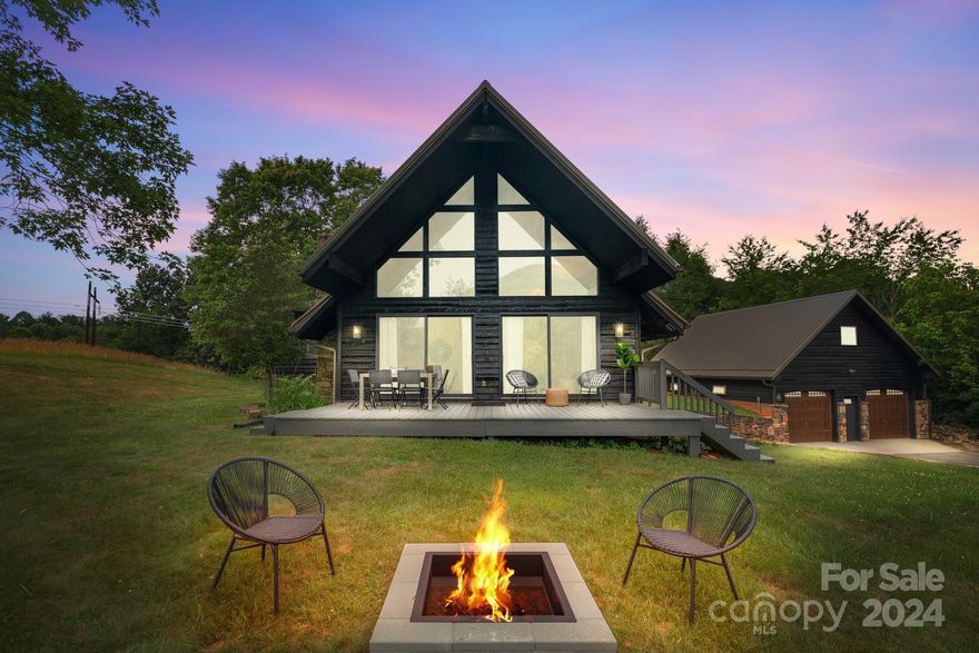 Welcome home to your new A-Frame! This newly renovated 2 bed, 3 bath home plus detached guest suite is located on five beautiful rolling acres.  This home has operated as a successful vacation rental and is being sold fully furnished. The living room features a gorgeous floor to ceiling wood burning fireplace and large windows to take in the stunning year-round views.  The main floor has an updated kitchen, dining room, full bath, and one large bedroom with glass sliders out to the hot tub and back deck. The upstairs has an additional bedroom and full bath. The basement has been turned into an awesome bunk and game room, complete with air hockey and Pac-Man machine and has another full bath with laundry. Enjoy your coffee on the front deck while admiring the view or unwind at the fire pit. Don't forget to check out the brand-new guest suite with kitchenette and full bath above the oversized, detached two car garage. This house has it all and is only a 20-minute drive to downtown AVL!