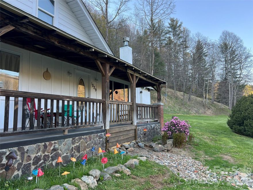 Totally remodeled 3 bedroom, 2 bath home. Brand new roof, electric and plumbing throughout, new walls, flooring, ceiling, and bathrooms.  New LG Studio Series appliances including the washer & dryer, stand alone new freezer that all convey along with the 2 hutches in the kitchen and white hutch in the storage room. Full attic with pull down ladder provides ample room for storage etc.  This home is turn key and ready for you to sit on the covered front porch and enjoy the beautiful mountains surrounding the area.  Over an acre with plenty of flat usable land with an old barn that is ready to be updated! Please see the Features List in attachments.  Only 5 miles from downtown Burnsville and 30 minutes to Asheville. Be sure to check out the bonus room that is accessible from the ladder in the back of the house! No damage from Hurricane Helene.