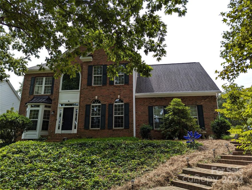 Stately 2 story home in a waterfront community with a boat slip!  Stylish updates include painted interior, new carpet in 3 bedrooms, LVP vinyl plank floor on main, halls, and primary BR added in 2019 along with kitchen update with granite tops.  Master bath features a tiled shower and free-standing designer tub!  Additional features include new insulation and vapor barrier in crawl space, oversized garage with sink, fenced backyard and brick patio, SS appliances, gas stove, and water heater recently replaced.  Front yard has appealing brick stairs and patio area, and private drive in back provides convenient access.  The amenity-rich community is on beautiful Mountain Island Lake, Only 25 minutes from uptown!  Community amenities include boat ramp, clubhouse, pool, tennis courts, soccer field, playgrounds and recreation area. US National Whitewater Center and new Riverbend Village Center nearby.  Park your boat in the convenient boat slip for easy access to the lake!