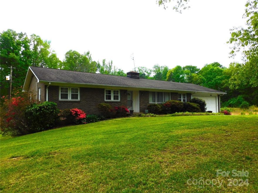 Wonderful all brick home on 7 plus acres with a pond and outbuildings! Over 1900 heated sq ft plus a full walkout basement.  Upstairs bosts 3 bedrooms and a bath with a formal living, dining and eat in kitchen ( needs updating)  Den with woodburning fireplace and covered sunporch. Finished basement has recreational room with walk out door to rear yard and wood stove, 2 bedrooms and bath.  Basement needs a modern heating and cooling system.  Property includes a small pond, outbuildings and the old Kings Creek post office at entrance to the property.  Approximately 4 acres of woods.