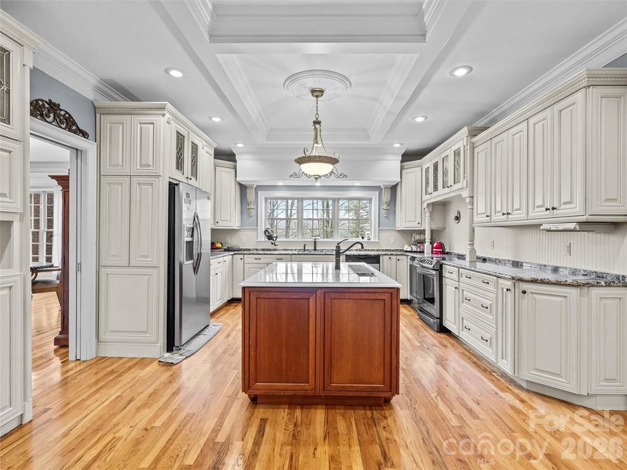 Welcome to Cedar Rock Estates, where luxury living meets the comfort and convenience of a country club lifestyle. This expansive 6,422 square foot home offers a refined mountain setting with wooded privacy, elegant finishes, and access to the full amenities of Cedar Rock Country Club, including golf, tennis, a pool, clubhouse dining, and year-round social events. Located minutes from the Blue Ridge Parkway and a short drive to Hickory, Boone, and Blowing Rock, this is one of Lenoir’s signature luxury homes.

The main level features a grand two-story entry with a sweeping staircase, formal living and dining rooms, a spacious kitchen with large island and breakfast area, a den with fireplace, a bedroom, laundry room, and a half bath. Crown molding, custom millwork, and large windows create a bright, elevated living experience.

Upstairs you will find the primary suite with a sitting area and fireplace, a generous bath with garden tub and walk-in shower, dual closets, and access to an additional laundry space. Two more bedrooms, two full baths, an exercise room, and a large bonus room complete this level, offering ideal flexibility for family living, work-from-home needs, or multi-generational arrangements.

The third floor adds another oversized bonus room and a full bath, perfect for a media room, guest suite, or private retreat. An elevator serves all levels and is currently non-functional, giving the next owner significant future potential.

Outdoor living includes a front porch, rear patios, and a private setting surrounded by mature trees. The sloped terrain provides a natural backdrop and low-maintenance landscape design, ideal for buyers who prefer privacy and outdoor relaxation over yard upkeep. A three-car garage, paved drive, and Starlink Internet service enhance everyday convenience. The driveway is steep, typical of the community’s terrain, and offers excellent privacy once at the top.

This home delivers an exceptional combination of size, quality, privacy, and lifestyle amenities within one of Caldwell County’s premier neighborhoods. Experience country club living, mountain proximity, and luxury space all in one address.