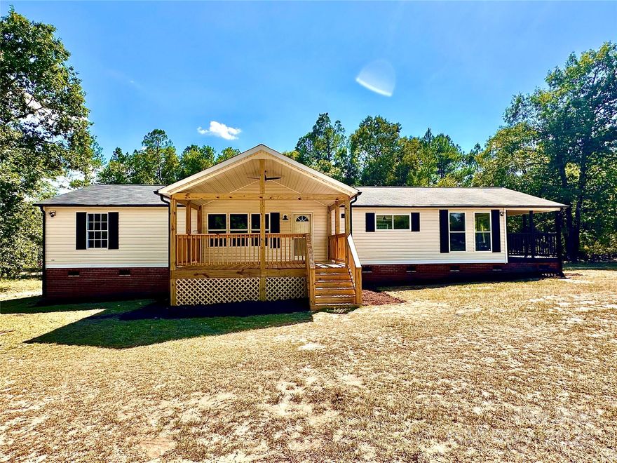 Beautifully renovated 3BR/2BA manufactured home on a spacious 1-acre level lot! This move-in ready home features a desirable split bedroom floorplan with a large great room, cozy fireplace, and soaring cathedral ceiling. The updated kitchen boasts an island, all-new appliances, and stylish finishes, opening to a bright dining area. Enjoy new LVP flooring, fresh paint throughout, and updated light and plumbing fixtures. The primary suite offers a spa-like bath with a soaking tub, tiled shower, and marble-top double vanity. Two additional bedrooms share a fully updated hall bath. Relax on the covered front or side porch and enjoy peaceful evenings in this serene setting.