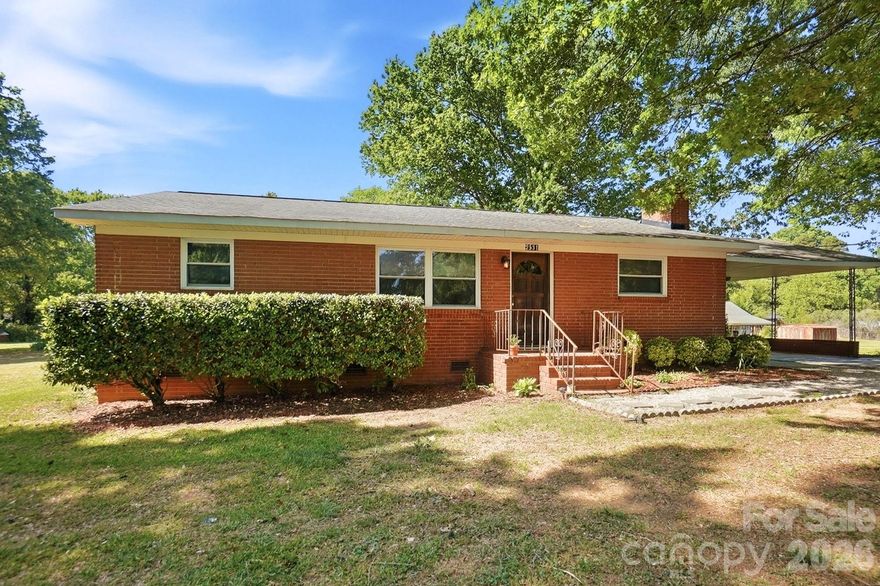 Welcome to this full brick ranch situated on a spacious 0.59-acre lot in a prime location close to shopping, dining, and everyday conveniences! This home offers incredible potential and is the perfect opportunity for buyers looking to update, renovate, and make it their own.

Inside, you’ll find an open-concept layout featuring a large kitchen with breakfast bar that flows into the expansive living room with a fireplace—creating a great foundation for modern living and entertaining. A bonus room/enclosed porch adds valuable flex space, ideal for a sunroom, office, or additional living area.

The home offers 3 generously sized bedrooms and 2 full bathrooms, providing a solid layout ready for your personal touch.

Step outside to enjoy the large covered back patio along with a covered carport/extended patio area—perfect for outdoor gatherings or additional parking. The property also includes two sizable storage buildings, offering plenty of space for tools, hobbies, or workspace needs.

The deep, private backyard backs up to mature trees, creating a peaceful and natural setting with plenty of room to expand, garden, or design your dream outdoor oasis.

Located with easy access to Hwy 74 and Old Monroe Road, this home combines convenience with space—and best of all, no HOA!

Don’t miss this chance to transform a well-built home in a great location into something truly special.