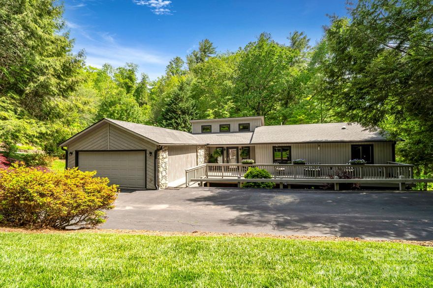 Discover the perfect blend of comfort, space, and natural beauty in this 4-bed, 4-bath contemporary ranch in South Asheville. With stone accents and multiple decks overlooking peaceful wooded views, this home offers a lifestyle as impressive as its layout.

Step inside to a grand living room with 15-ft vaulted ceilings and a stunning stone fireplace. The updated kitchen features granite countertops, a large island, a breakfast area, and a walk-in pantry with custom built-ins. Host with ease in the formal dining room, ideal for gatherings and celebrations. An oversized garage provides seamless, step-free access to the main level of the home.

Enjoy true main-level living with a spacious primary suite boasting two walk-in closets, plus a guest bedroom, laundry area, and a serene screened-in porch. The fully equipped lower level—complete second kitchen, oversized family room with fireplace, two bedrooms, and a jumbo flex room—is perfect for guests or multi-generational living.

Just minutes from the Blue Ridge Parkway, Biltmore Park, and downtown Asheville, this home offers convenience without sacrificing privacy. Sellers will provide a home warranty for added peace of mind.