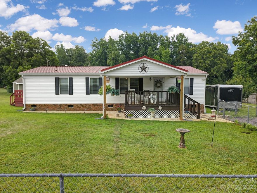 Are you seeking land and no HOA? Look no further! 1.42 Acres! Come and see this adorable, well taken care of manufactured home. There are 3 bedrooms and 2 full baths! The yard is fenced in and there is a deck on front and back of home. Front porch is covered. There is a metal carport that is 18x20. There is also a storage building wired that is 12x20.  This home will not last long and is priced to sell. This home is de titled and engineer cert was completed on 6/21. Septic emptied in 2022. There are new gutters on home. There is a new water line from house to road. Professional photos will be on in a few days.
