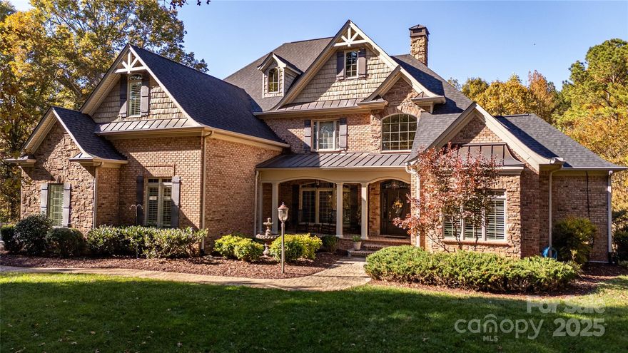 Discover refined living at this private 12± acre estate in the desirable Country Club area of Kings Mountain. Located at the end of a paved road, this residence offers exceptional privacy and seclusion—just minutes from town.
The Chef’s Kitchen features porcelain tile floors, custom cabinetry, granite countertops, and a spacious walk-in pantry and laundry. The open living and dining area showcases vaulted ceilings, hardwood floors, and a gas fireplace, while the newly completed covered porch overlooks the saltwater pool with Trex decking, stone fireplace, heaters, fans, and TV.  The main-level primary suite includes a walk-in closet and a spa-like bath with custom cabinetry, walk-in shower, and whirlpool tub. Upstairs are two bedrooms with walk-in closets, a Jack and Jill bath, a bonus room, and storage.  The full basement offers a second kitchen, living room with fireplace, walkout access to the pool, playroom, game room, home office, and exercise space. Outdoor living shines with a cabana, outdoor shower, gas firepit, and a third chef’s outdoor kitchen featuring premium appliances and granite countertops.
Additional features include plantation shutters, custom murals, attached and detached garages with workshop, and a pool changing room—luxury country living at its finest.