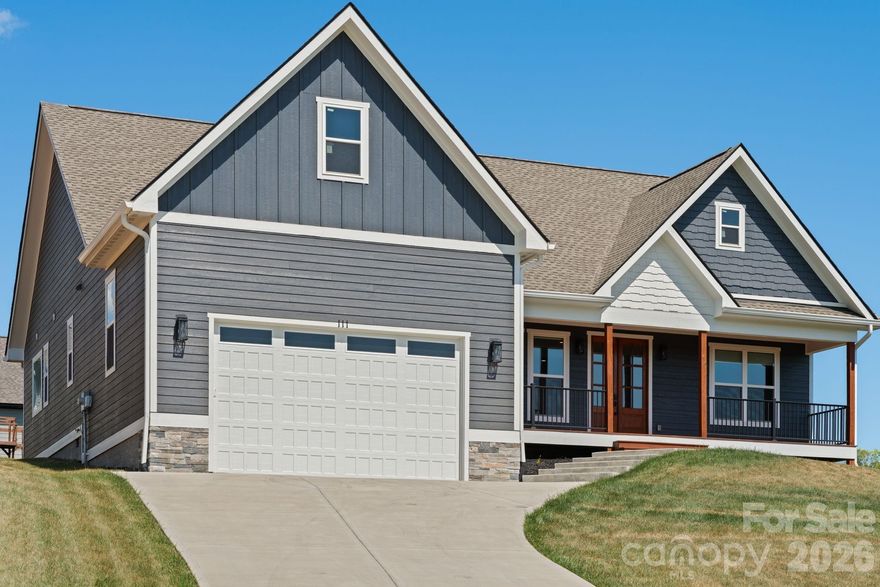 One level living at it's finest! Built in 2023, this beautiful Candler home offers luxury finishes, such as LP Smart Siding, quartz countertops, tray ceilings with wood beam accents and custom lighting, just to name a few. Before stepping inside, take in the best mountain views in the neighborhood on your "rocking chair ready" front porch! As you make your way inside through the gorgeous French doors, you are greeted with an open floorplan flooded with natural light from the floor to ceiling windows. The gas fireplace in the living room is a stunning statement piece that you will enjoy warming up to all winter long. A timeless, white kitchen gleams against the dark tile backsplash and the large eat at island makes it perfect for entertaining. Want to enjoy dinners outside on warm evening? Head out back to the screened in back porch just off the kitchen! A split floorplan offers privacy for the primary suite that boasts a beautifully tiled bathroom with a soaking tub, separate vanities and large walk in closet with custom built-in shelving. Two guests bedrooms with a full bathroom situated just off the living room are perfect for guests or family. The two car garage offers tons of extra space for storage or a workshop area!