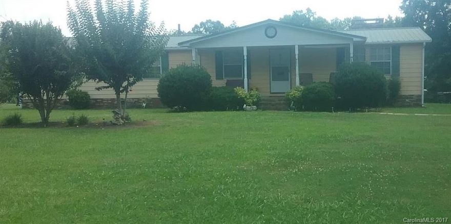 Beautiful lot with many mature trees. Tin roof, 2 covered porches. Back porch brick enclosed, nicely done. Mstr bath remodeled w/in last 2 years, new shower enclosure. Lots of closet space throughout. Home could be converted back into 3 bdrm. Kitchen cabinets & flooring upgraded. Beautiful fireplace.