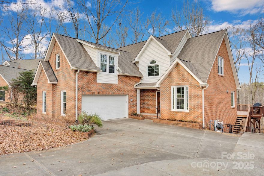 Beautifully updated brick, 2-story home with a finished walk-out basement. Recent upgrades include new LVP flooring, fresh interior paint, roof (10/2021), windows (2024), and tankless water heater (2022). The main-level primary suite is a true retreat, featuring a dual tray ceiling and spa-inspired bath with jacuzzi tub, steam shower, dual vanities, heated towel rack, smart lighting, and walk-in closet. Main level also offers a 2-story foyer, formal dining room, vaulted great room, kitchen with stainless appliances and gas range, breakfast area, laundry, and powder room. Upstairs includes two bedrooms, a full bath, and an oversized third bedroom/bonus room. Finished basement features a large entertainment area with pool table (conveys), full bath, storage, and walk-out access to a spacious backyard. Outdoor living shines with a deck, expansive patio, wood-fired oven, and smoke pit...ideal for entertaining! Home backs up to access to the Charlotte Greenway. Refrigerator, washer, dryer, and pool table w/ping pong table topper all convey with the home. Seller offering 1yr home warranty! Please see attachments for smart home features, survey, and impervious overage details.
