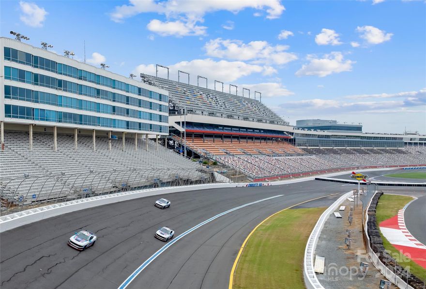 Race fans and luxury seekers alike, this is your dream come true! This unique 2 Bedroom, 2 Bathroom condo is one of the finest units in the building and offers a one-of-a-kind view overlooking the legendary Charlotte Motor Speedway. Imagine relaxing in your living room while watching the excitement unfold right from your wall of floor to ceiling windows! Unit #205 showcases an updated interior with beautiful wood floors and redesigned layout perfect for entertaining. The sleek kitchen features stainless steel appliances, bar top seating and ample storage. Many of the stylish furnishings to convey with the condo, making it move-in ready and perfect for enjoying the space from day one. From modern finishes to spacious living areas, every inch of this home speaks to comfort and style. Whether you're hosting race day parties or just soaking in the atmosphere, this unit promises an unbeatable experience. Don’t miss your chance to own the ultimate Speedway view!