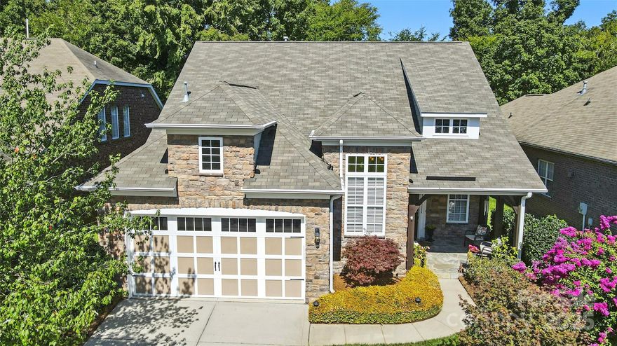 Great new price on a great home!! Fabulously upgraded full brick/stone home in the premier Saddlebrook Community of Stone Creek Ranch. Great curb appeal with lush landscaping, a flagstone front patio, and a beautiful leaded-glass entry door. Step inside to a dramatic two-story foyer with hardwood stairs, runner, wrought iron balusters, and lots of hardwoods. Enjoy a formal dining room with tray ceiling, a cozy great room with fireplace, powder room, and a functional laundry/mudroom with storage. The kitchen offers generous workspace and style with Silestone counters, stainless steel appliances, smooth-top range, 42” cabinetry, deep sink, and excellent pantry space. Fantastic owner’s suite (with more hardwoods) includes an updated/remodeled bath with dual vanities plus makeup area, soaking tub, a large frameless-glass walk-in shower, custom tile, and a walk-in closet with organizers. Upstairs, you’ll find a spacious landing with hardwoods, large secondary bedrooms with walk-in closets, a hall bath with double sinks, and exceptional storage. Beautiful 285 sq ft tiled sunroom with ceiling fans plus a travertine patio overlook a fenced, manicured backyard backing to a wooded common area for privacy. Insulated garage door & irrigation. Roof (2020); HVAC and water heater (2022). HOA covers yard maintenance, shrubs & pine straw. Stone Creek Ranch amenities include a clubhouse, pool, and playground, all minutes to I-485 and the shops/dining/entertainment of Stonecrest, Rea Farms, Waverly, and Blakeney. Must see!