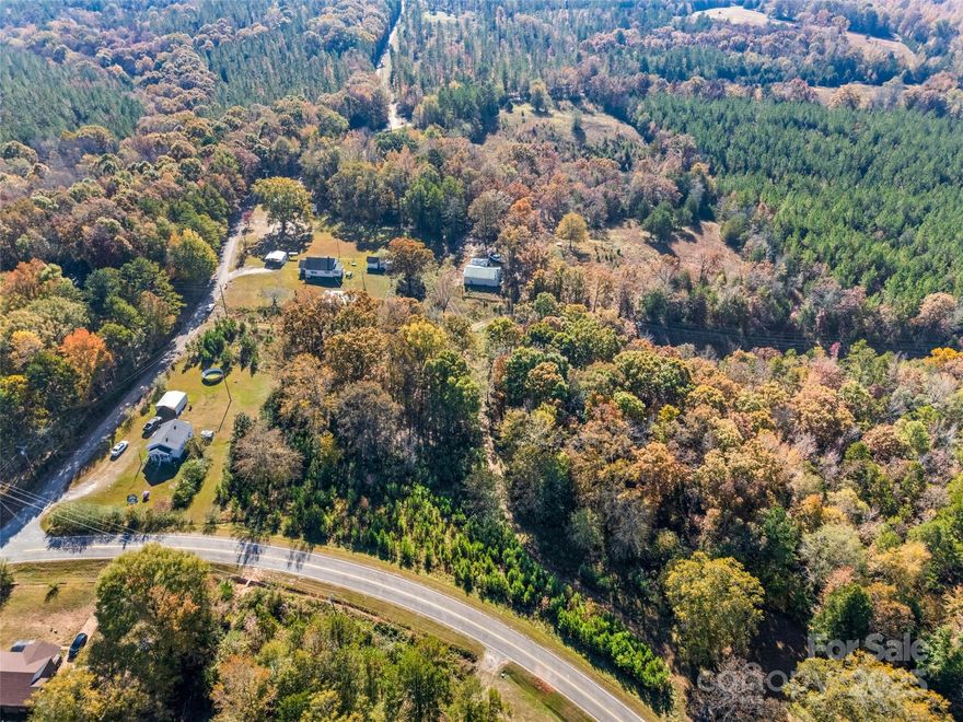 With no restrictions and three points of access (Old Union Rd and two from Sunnyside Dr), this land offers flexibility for a homesite, hobby farm, or future development. Approximately 7 acres are cleared, fenced, and ready for livestock, complete with two cattle gates, while the remaining wooded acreage provides privacy, shade, and natural beauty. The property includes a large 40’ x 40’ metal farm building/garage, a two-room workshop (12’ x 28’), a metal carport, and a divided chicken coop—ideal for those seeking functional outbuildings and plenty of storage. County water hookups are available at the road, or you can drill a well for complete independence. With multiple prime building sites, gentle topography, and open pasture views, this land is ready for your dream home, mini-farm, or investment project. Conveniently located near downtown Union yet tucked away for peaceful country living.