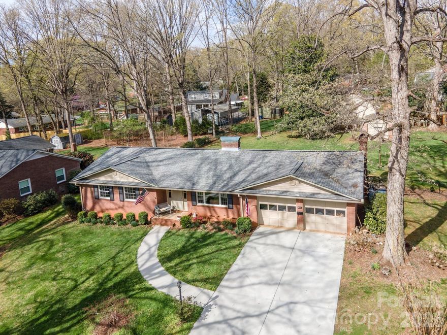 Step into comfort, space, and thoughtful upgrades in this sprawling ranch designed for both everyday living and all your hobbies. From the moment you arrive, the concrete driveway and inviting setting set the tone for what’s inside. The great room welcomes you with a beautiful granite fireplace, built-ins, and an open flow into the dining area—perfect for gathering. The updated kitchen is truly the heart of the home, featuring granite countertops, a center island with seating, gas cooktop, GE Profile oven, deep sink, new tile flooring, and abundant cabinetry with convenient pull-outs. Open to the kitchen is the cozy den with a second fireplace. An exterior door to a screened porch and covered outdoor space—ideal for relaxing evenings or entertaining. Access to a walk-in cellar with a new vapor barrier. All bedrooms showcase original hardwood floors and natural light. The primary suite offers a walk-in closet, an additional closet, and a private bath. For those needing extra space, this property delivers: attached 2-car garage, fenced yard, tall RV/boat carport, workshop shed, and a detached single garage—room for vehicles, hobbies, and more. With major updates already completed—including roof, windows, gutters, plumbing, and HEAT PUMP—this home offers peace of mind along with exceptional functionality.