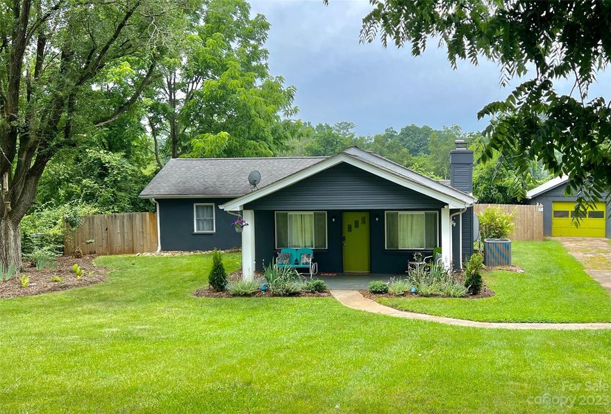 Welcome to the epitome of groovy living! This updated/stylish 2-bedroom, 1-bath home offers a single-level oasis w/ a vibe that's as cool as it is comfortable. Nestled just minutes from Downtown Asheville. The open floor plan adds a sense of spaciousness, creating a perfect atmosphere for entertaining or simply kicking back and enjoying the good vibes. Beautifully updated, this home boasts a personality that's as unique as it is appealing. Beyond the stylish interior, the flat yard provides an ideal setting for outdoor activities or creating your own mini oasis. The fenced backyard, complete w/ a one-car garage, adds a layer of convenience and privacy, making it the perfect spot for gatherings, pets, or just unwinding after a day in the city. Located in the Woodfin tax district, approved as an Airbnb, this property offers both residential charm and an income stream. The house could come furnished w/ an acceptable offer, allowing you to effortlessly step into your new, groovy lifestyle.