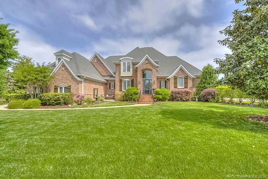 Beautiful Tom Stevenson Custom Brick home with great architectural detail situated on a large beautifully landscaped golf course lot. Interior details include open gourmet kitchen with granite, cherry cabinets, extensive beautiful hardwoods. Master on main level, gracious formal areas for entertaining & generous outdoor patio/ screened patio/open kitchen/breakfast/gathering area for family country club living.