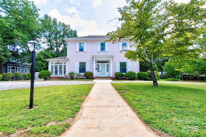Timeless charm meets modern updates in this impressive 5BR/3.5BA traditional two-story home, ideally located on a beautiful tree-lined street just minutes from uptown Shelby. Known by locals as The Raymer Place, this historic-district property offers a rare blend of character, space, and versatility.  Inside, you’ll find restored hardwood floors (2025), expansive formal and informal living areas, and multiple fireplaces that add warmth and elegance throughout. The kitchen was thoughtfully remodeled in 2021 and features granite countertops, stainless steel appliances, and abundant cabinet space—perfect for both everyday living and entertaining.  Enjoy year-round relaxation in the sunroom or step outside to the rear deck overlooking a fenced backyard, ideal for gatherings or quiet evenings outdoors. Additional highlights include two staircases, a basement workshop with storage, ample parking, and all appliances remaining. Major system updates include a new HVAC system with ductwork installed in 2020.  Previously used as both a private residence and a business, this home offers incredible flexibility—ideal for a home office, home salon, or potential bed & breakfast (buyer to verify zoning/use). Conveniently located near shopping, dining, the library, and the park, this one-of-a-kind property offers endless possibilities. Call today to schedule a showing!