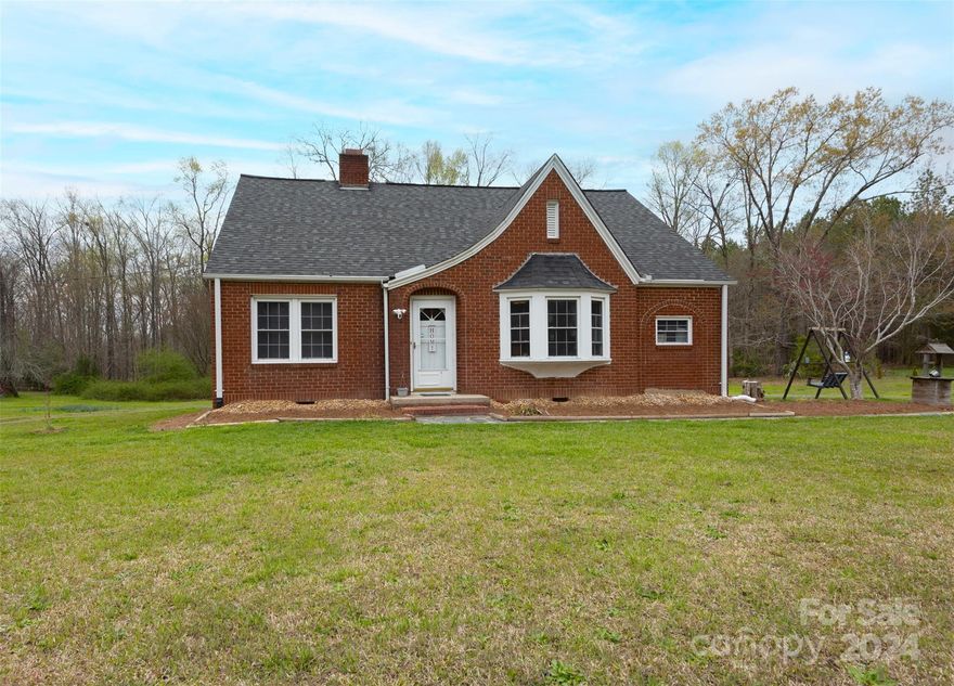 A BRICK home on just under 1 acre for less than 200K!! This charmer offers 3 beds, 2 baths, original hardwood floors, a cozy living room with a fireplace, formal dining room, galley style kitchen and a bonus space upstairs currently functioning as a 4th bedroom. More space than meets the eye! Situated on a huge lot with great front yard curb appeal, easy come and go half-circle driveway and tons of backyard space for all the outdoor living ideas you can dream up. SO MUCH potential inside and out! New vapor barrier and water heater. Located within an easy driving distance to shopping, restaurants, Uwharrie National Forest and Lake Tillery. Welcome home!