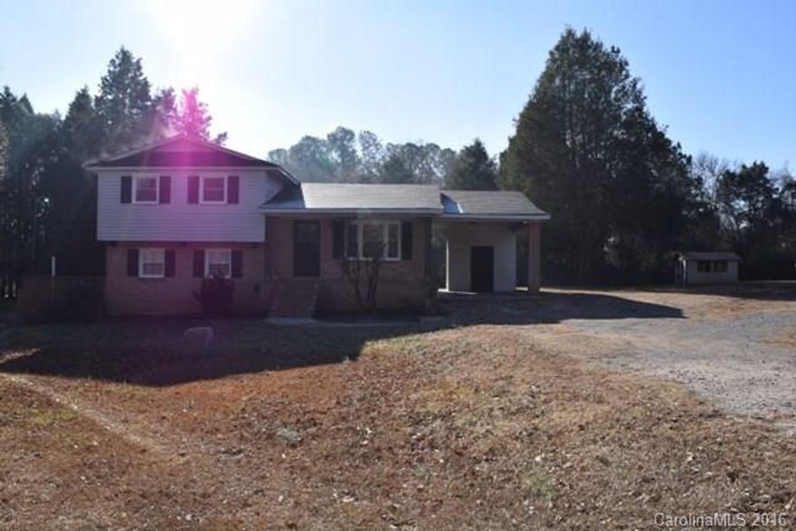 This cute tri-level home sits on 1.5 acres and well maintained.  Beautiful hardwood floors in bedrooms upstairs, living room and tile in kitchen.  Lower level has great room and another bedroom.  Freshly painted interior.  Newer HVAC system, single carport and storage shed.  Great access to I-77 and Hwy 9.  Buyer agent to verify schools.