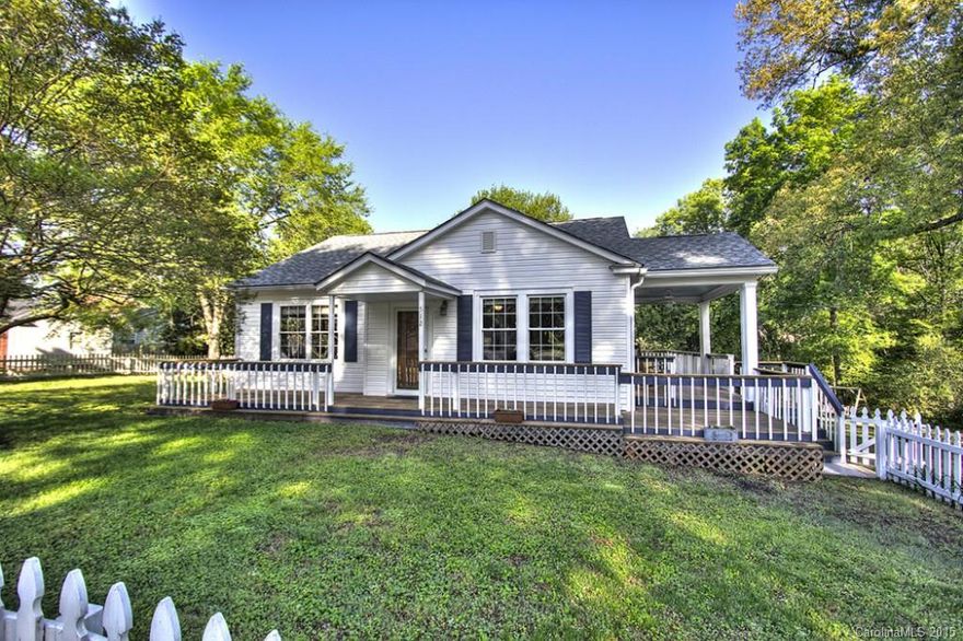 What a charming bungalow framed by picturesque white picket fenced.  Image lazy mornings & cool summer evenings on covered porch wrapping 3 sides.  Perfectly situated in middle of 1/2 acre lot serving as a focal point for this quiet established neighborhood. Look long & hard to find anything with the amount of charm & detail of this home (estimated to have been built in 1950's). Wood floors throughout, tongue & groove walls & ceilings, replacement vinyl windows & roof '14. Master bath to wow!
