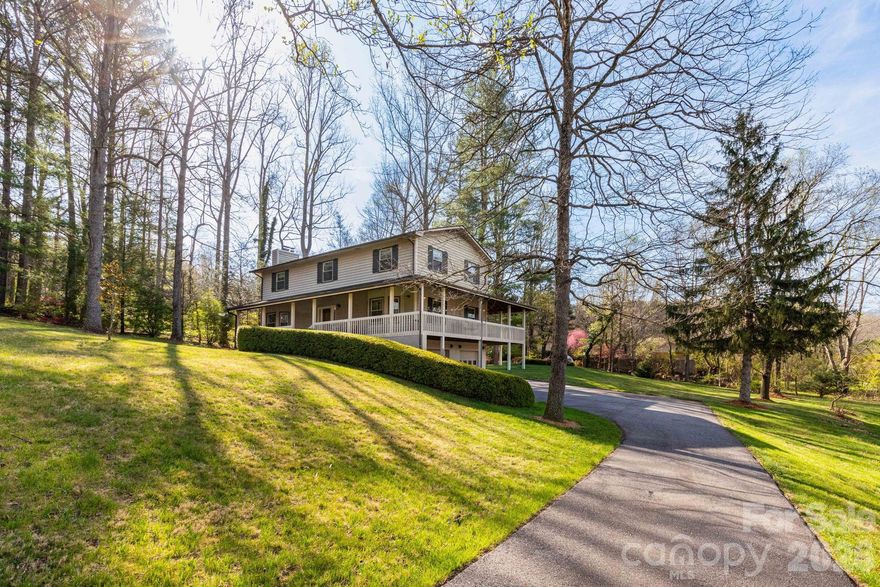 Serenity and location all in one!  Beautiful 4 BR 3 BA Farm Style house located in the desirable gated community of Fairview Downs.  Enjoy your morning coffee on the wraparound deck while taking in the long range views.  As you enter the home, the inviting foyer leads to one of two living areas one of which displays a gorgeous wood burning stone fireplace.  Hardwood floors throughout the main and upper level of the home.  Popcorn ceilings have been removed to display a fresh look along with recessed lighting throughout the main level.  The upper level of the home features four spacious bedrooms.  New energy efficient windows recently installed throughout the home.  The basement level features a countertop bar with sink and minifridge and offers easy access to the 2 car garage.  The backyard is perfect for relaxing by the firepit and has a ready to go invisible fence to keep your pups nearby.  Enjoy a sunset walk throughout the peaceful neighborhood or to the community park which features a gazebo, play area, and walking trail.  Located less than 10 minutes from Asheville, come see this picturesque home today!