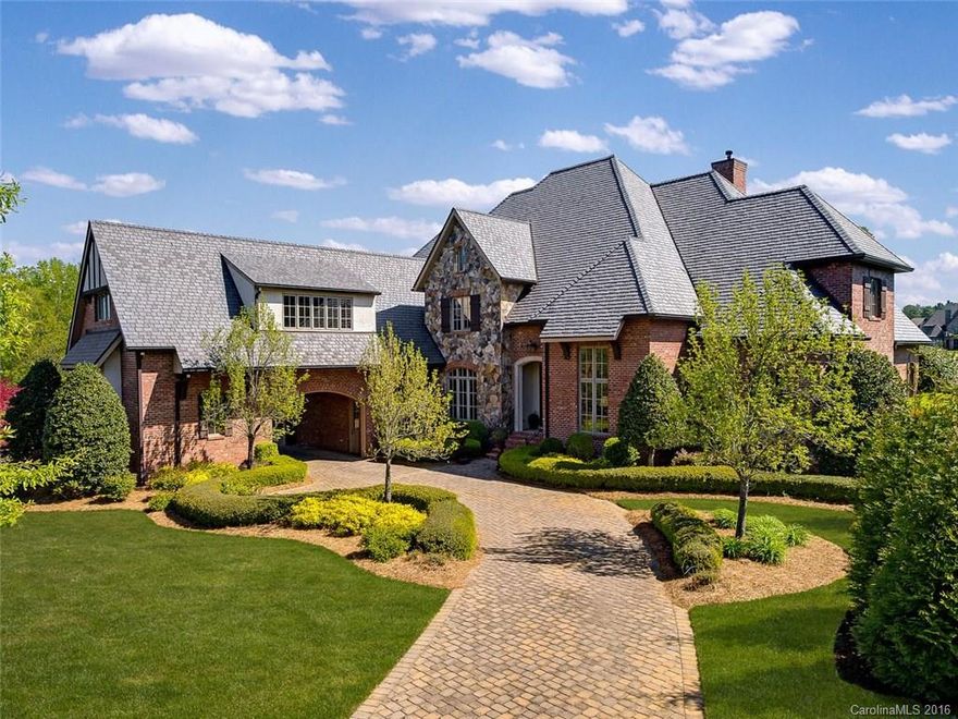 Elegant 5 bedroom, 5.2 bath home with golf course view. Gourmet kitchen w/antiqued glazed cabinetry, travertine countertops, walnut-topped work island, copper prep sink, complete w/top of the line appliances & breakfast area. Stone terrace w/tongue & groove ceiling, wrought iron railings, large yard, full irrigation system.  Main level masters suite & guest suite. Media & bonus room upstairs. Porte cochere side entrance, 3 single car garage bays with carriage doors. Beautiful details throughout.