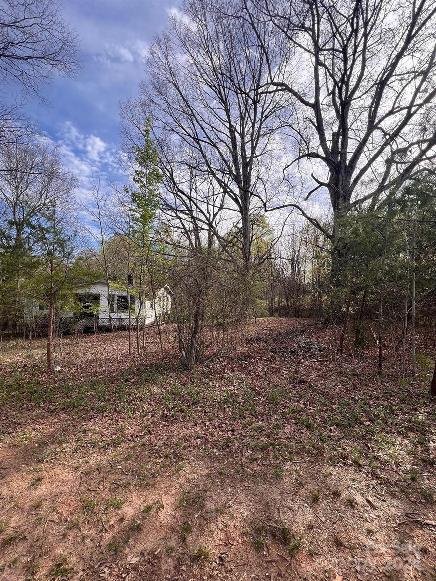 A great price on a half acre lot with very few restrictions! As of list date - there are no other listings on the market in Catawba County with .50 an acre for this price with no restrictions. There is an old home that appears to be on or partially on the property but it is not livable. Home has not been lived in for 35+ years according to neighbor. Home is unlocked but please do not enter because it is caved in and not safe. On GIS, it appears home structure may be straddling the property line - survey is recommended. No septic on record per county. Seller purchased in auction. Seller has never had a survey done and has no knowledge about property except what was told by a neighbor. Per county zoning dept-  a double wide can be put on property(see attachments for specifics). Lot would need new well and septic.