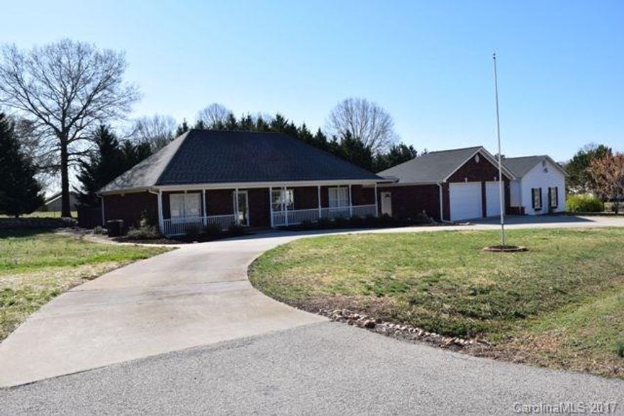 Brick ranch on over an acre corner lot! Vaulted great room and dining area.  Huge kitchen w/  beautiful flooring, easy shut cabinetry, and some w/ glass fronts as well a built in wine rack. Spacious bedrooms, granite vanities in both bathrooms. Nice deck w/ wraparound patio. Fenced yard is lined w/ privacy trees. The man in the family will LOVE this home. There is an oversized, detached, double garage w/ custom shelves to store all his toys and another detached shop for wood working or crafting.