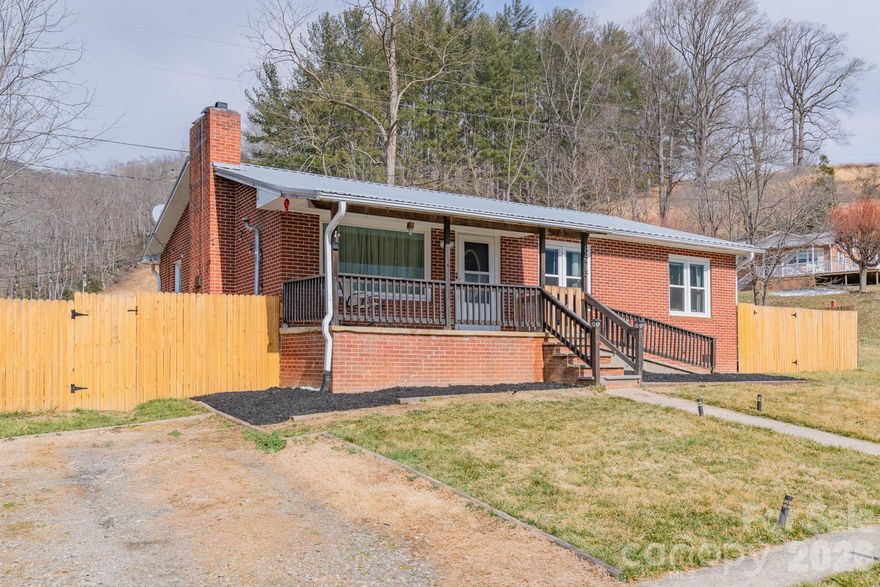 Move-In Ready! This recently updated sweet brick ranch is in the Cruso area of Canton, just across the road from the beautiful Pigeon River.  Swimming holes abound and hiking is close by!  10 minutes to downtown Canton.  35 minutes to Asheville.  Blue Ridge Parkway is just 20 minutes.  Fully fenced-in yard allows for pets and play.  Recently-installed 2024 mini splits provide heating and cooling, with an additional wood pellet stove for energy-efficient heat.  Barn-doors, wood trim, and ship lap create a cozy, rustic feel.  New fixtures, a welcoming fireplace, newly painted kitchen cabinets, and newer appliances offer a warm entertaining space.  One level living and a quaint low maintenance yard make this home perfect for any stage of life.  Recent survey.  New water heater December 2025.