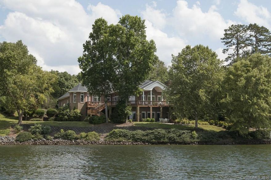 Panoramic lake views from this custom built waterfront home! Elegant entry with columns frames the immense open great room, overlooking the lake. Wrap around deck surrounded by glorious gardens and natural landscaping along the lake shore. Over 500' shoreline with TWO boat docks. Cooks will love the spacious kitchen with center work island, quartz countertops, breathtaking lake views. Main level master, luxury walk-in closet. Huge open rec room w/ 2nd kitchen, perfect for entertaining. See tour!