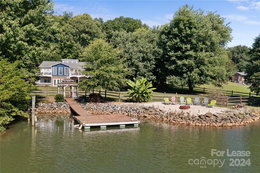 Rare lease opportunity of spacious waterfront estate with private beach and private dock and FULLY FURNISHED! Available for short term, long term or month to month. Plenty of room for large groups or families to enjoy this hidden piece of Paradise on Lake Norman! Home sleeps 12. Newer furniture and new landscaping guarantee a peaceful and spotless and clean staycation! Steps away from the water. Play gym in backyard is available as well! Plenty of decks and lounging areas to enjoy the views morning and at sunset! Great amenities and AMAZING location!! Enjoy the private beach and the large expansive backyard for room to play! Private 2 car garage and large driveway and two parking pads for guests. Plenty of parking for multiple cars. MANY spaces to entertain with multiple decks, patios, and areas for relaxing to watch the sunset.