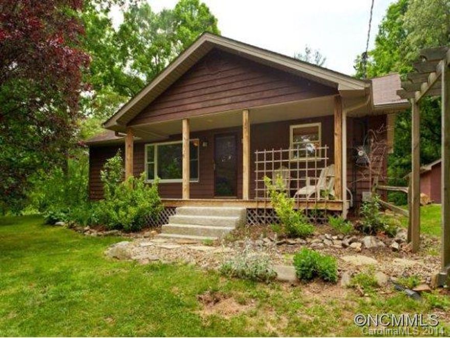 Beautifully updated home on .78 private acres located less than 5 minutes from downtown Asheville! County taxes, 2 detached garages (one heated with plenty of workspace)! The home boasts beautiful wood flooring, 2 master suites, stainless appliances, solid surface countertops, tile backsplash, formal living and dining, mature landscaping, and wrap-around decking perfect for entertaining. Private setting sits back off the road, come see!